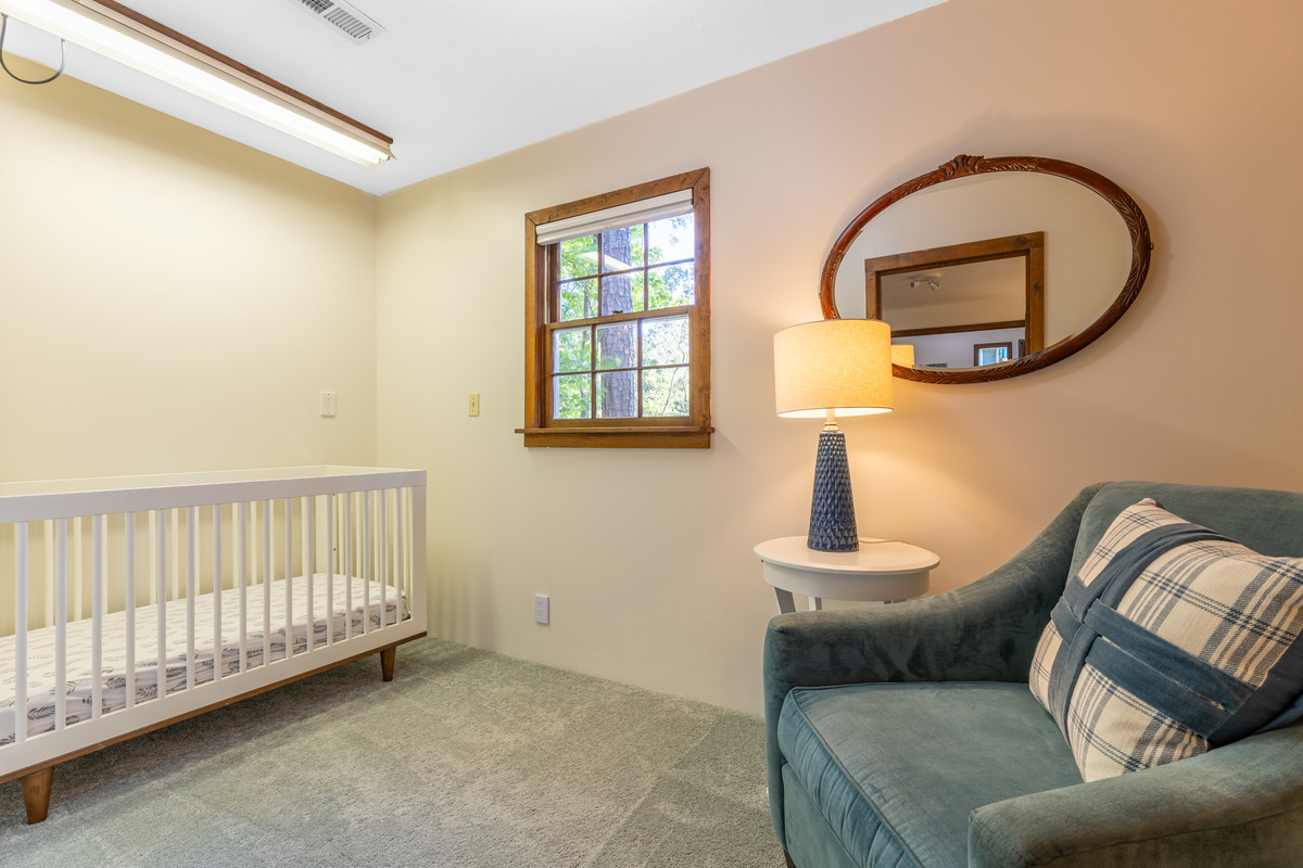 Off the lower-level bedroom, there is a perfect space with a crib and a comfy chair for families with young children. A variety of child-friendly supplies are at the house for guest use. 