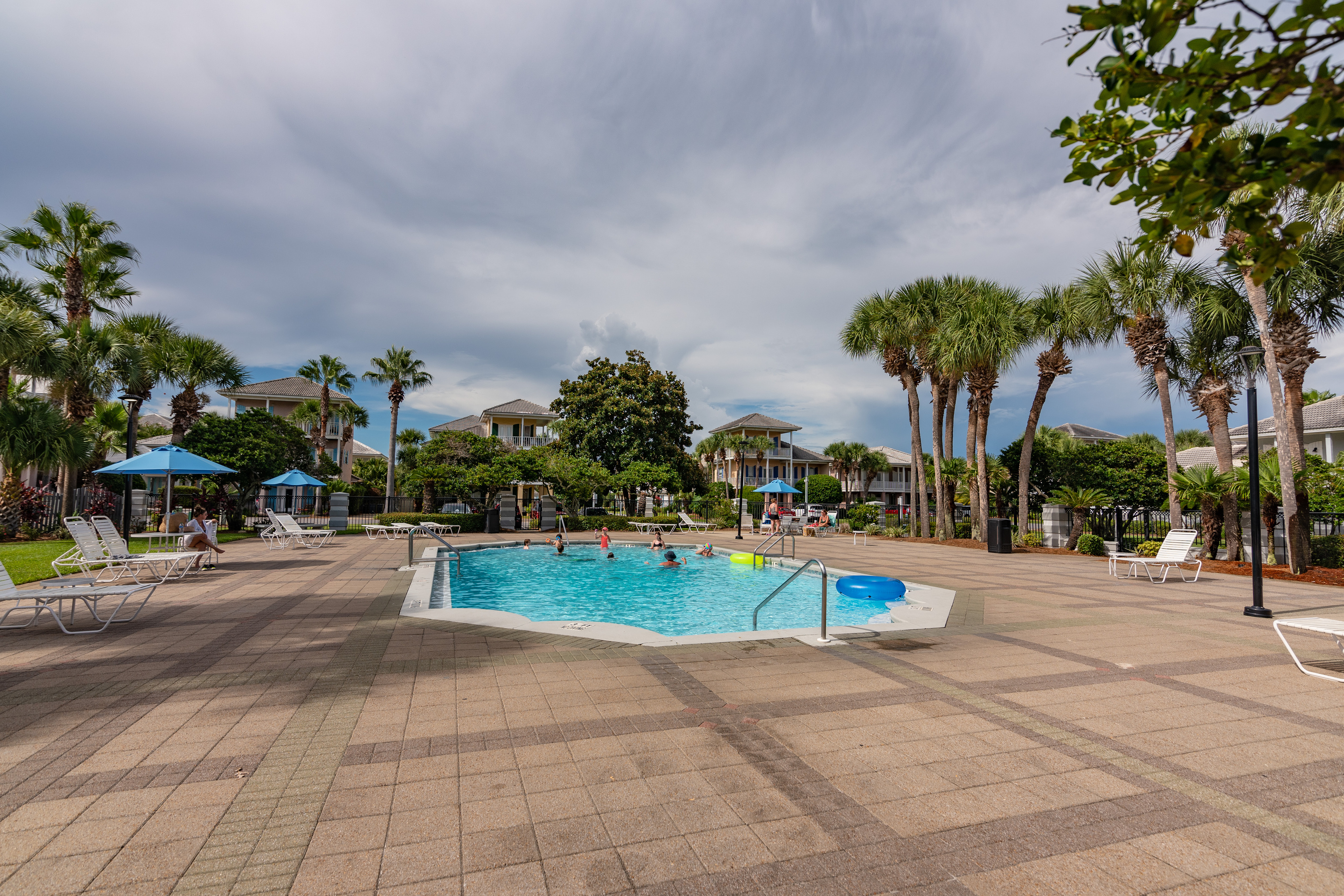 Resort‑style pool area with umbrellas and seating