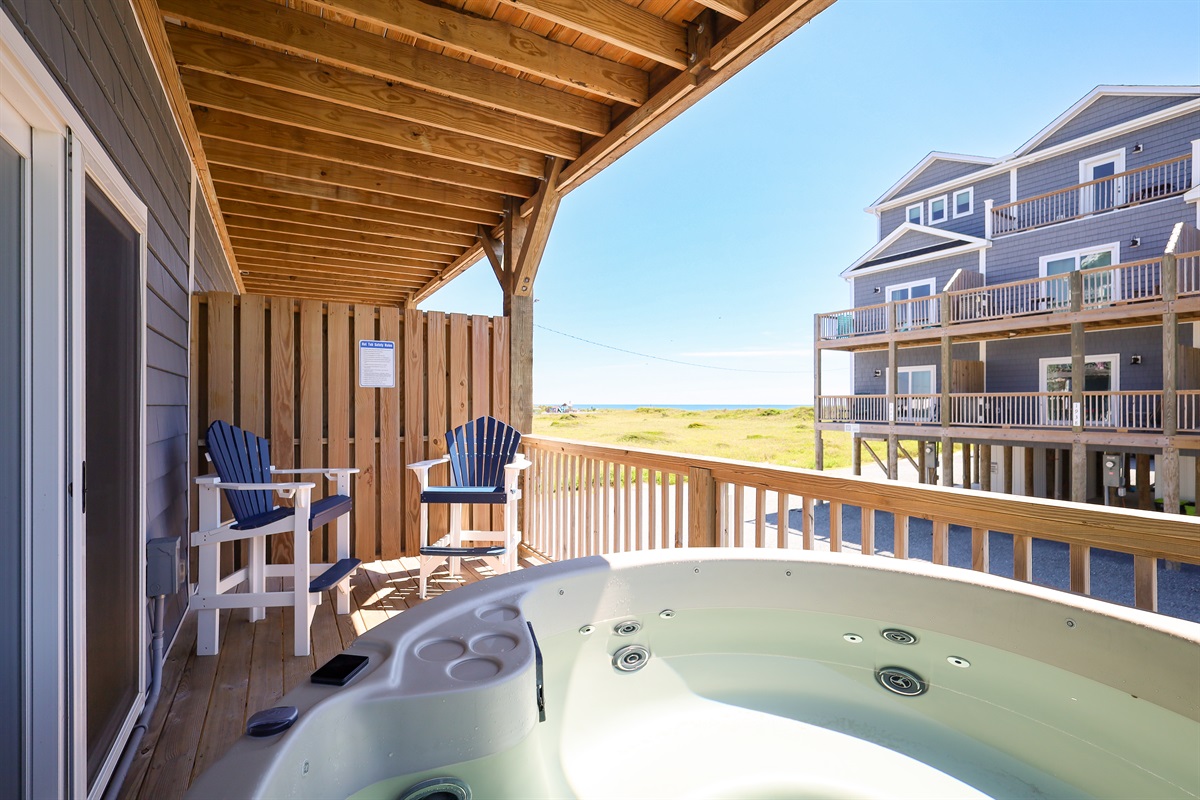 Relax on the balcony with ocean views and a bubbling hot tub