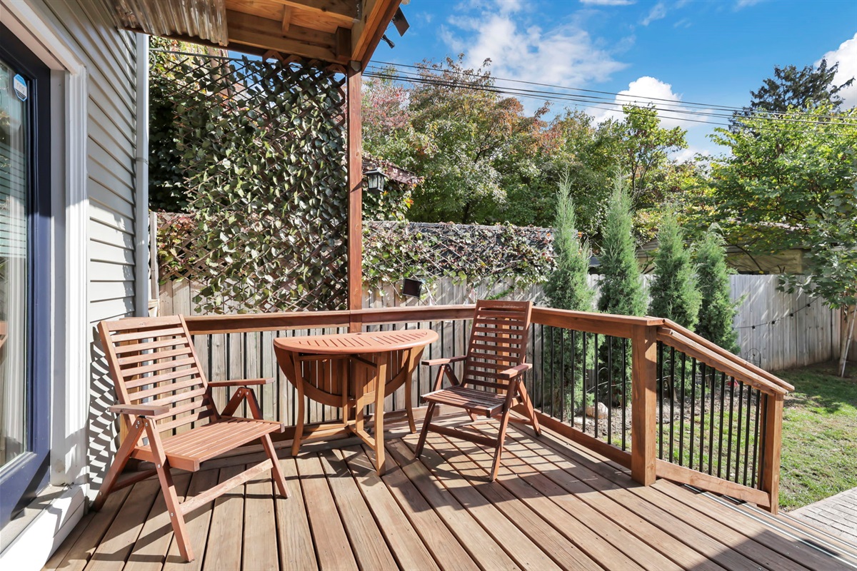 The back deck, with seating for two and a small table