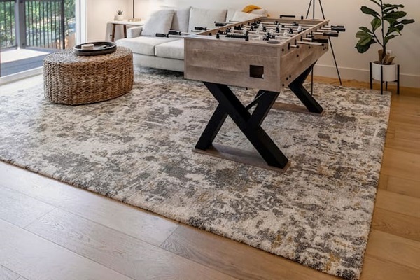 This is the game room downstairs, equipped with a 45-inch smart TV, a foosball table, and a PlayStation 5 with a selection of games.