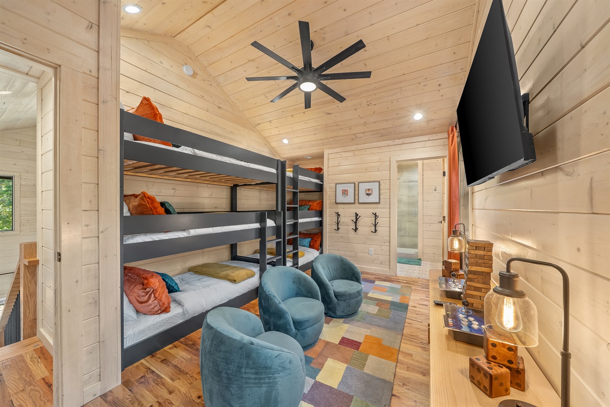 Kids and teens get their own retreat with triple bunks, cozy chairs, and plenty of space to play and unwind.