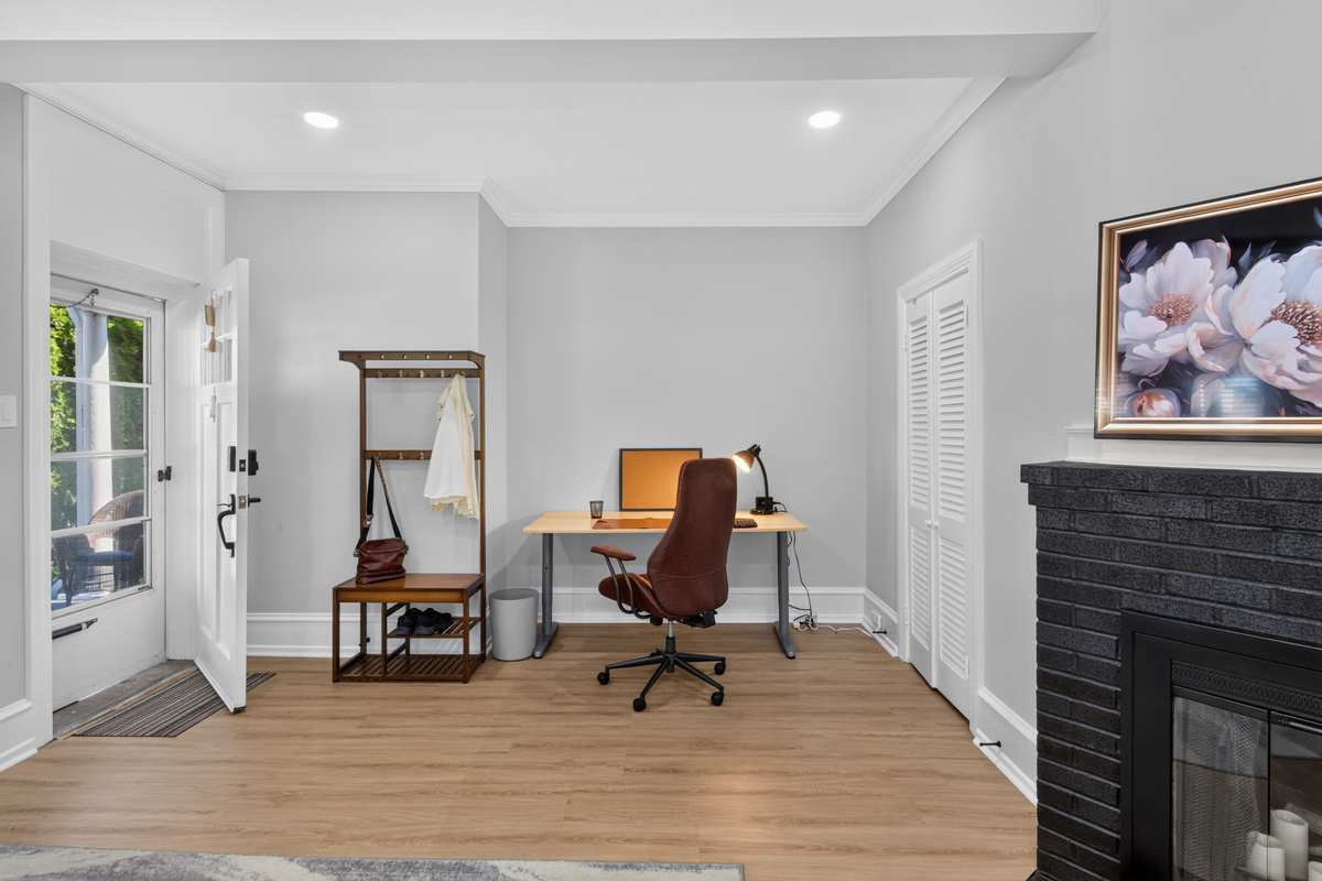 Welcoming entry with coat tree, fast Wi-Fi router, and decorative display fireplace.