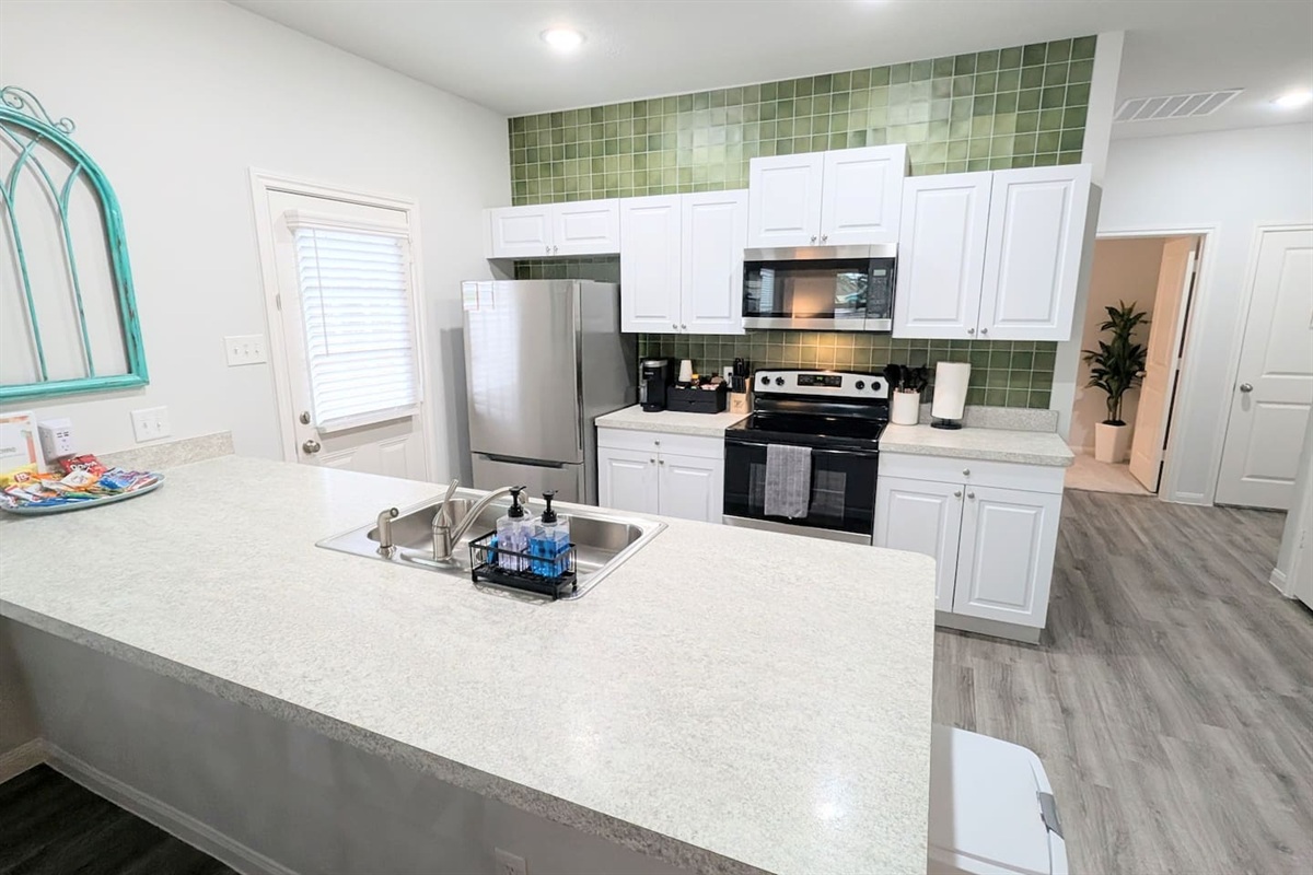 This fully stocked kitchen has a stove/oven, microwave, k-cup coffee maker, dishwasher, refrigerator, and plenty of space to make a delicious meal.  