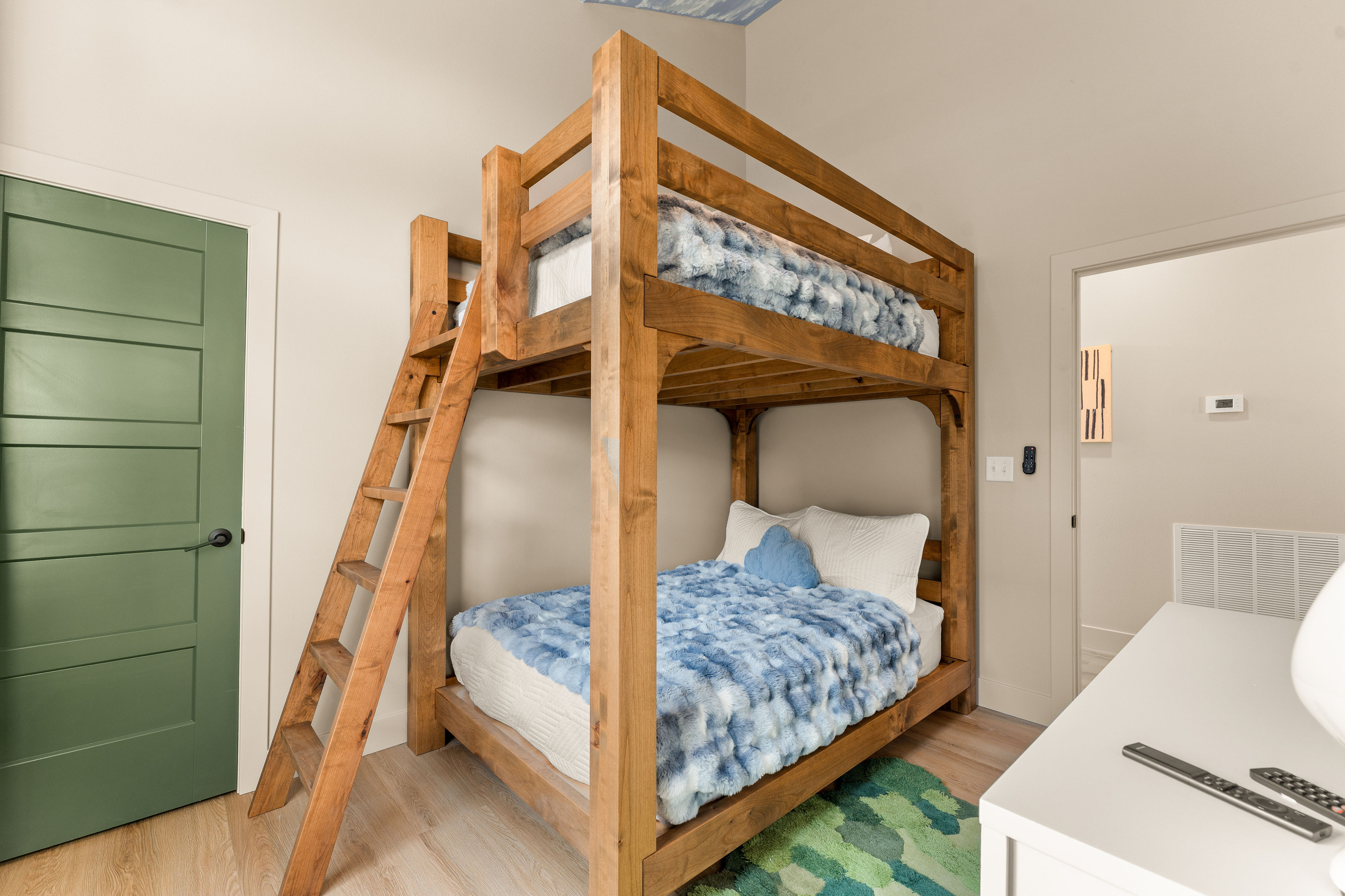Bunk Room – Second View
    Sturdy wooden bunks provide plenty of sleeping space, while playful colors and an imaginative sky overhead give this room its own storybook charm.