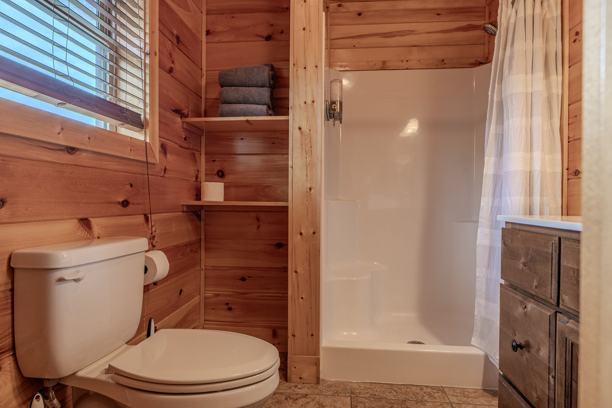 The Acoustic Suite Ensuite Bathroom adds private convenience to this upper-level king retreat, perfect for guests who want comfort and separation during a group stay.