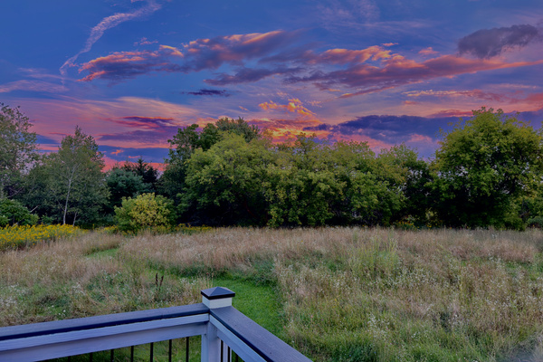 A rare visual feast over the meadow! While the deck faces east, stunning evening storm clouds and rare vibrant light shows occasionally illuminate the eastern sky.
