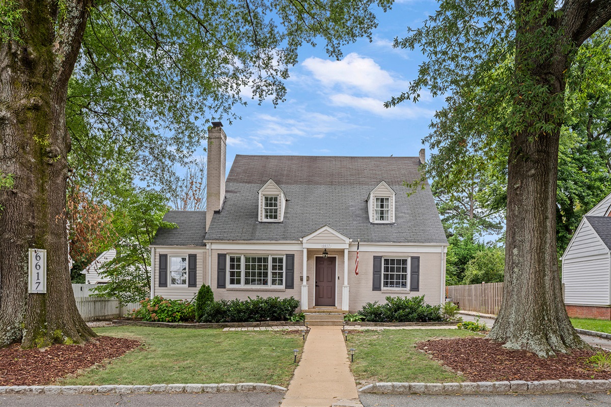 Exterior: Embrace Virginia charm in this lovely home, surrounded by lush greenery and warmth!
