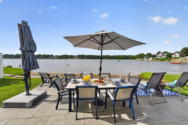 Gather around the outdoor dining table for meals with beautiful views of the water.