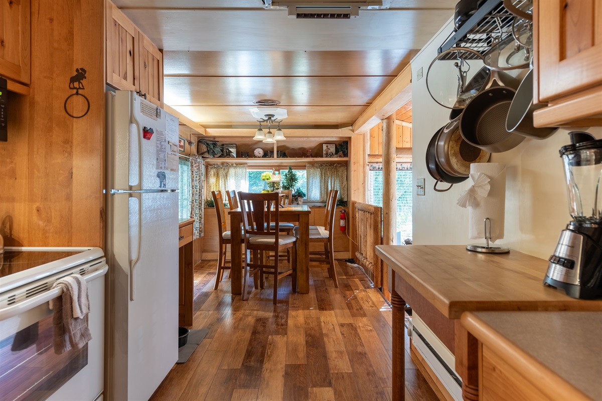 Well-equipped kitchen with essentials and a cozy dining area.