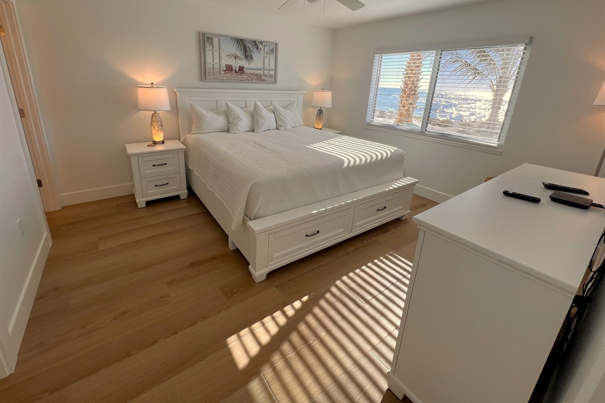 New gel king mattress and bedroom furnishings with views of the Gulf and Palm Trees.