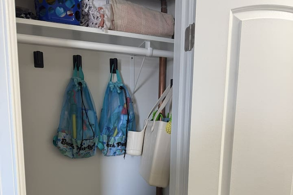 Closet with items to borrow for the Beach (towels, chairs, backpack & beach toys for kids).  Cleaning supplies.