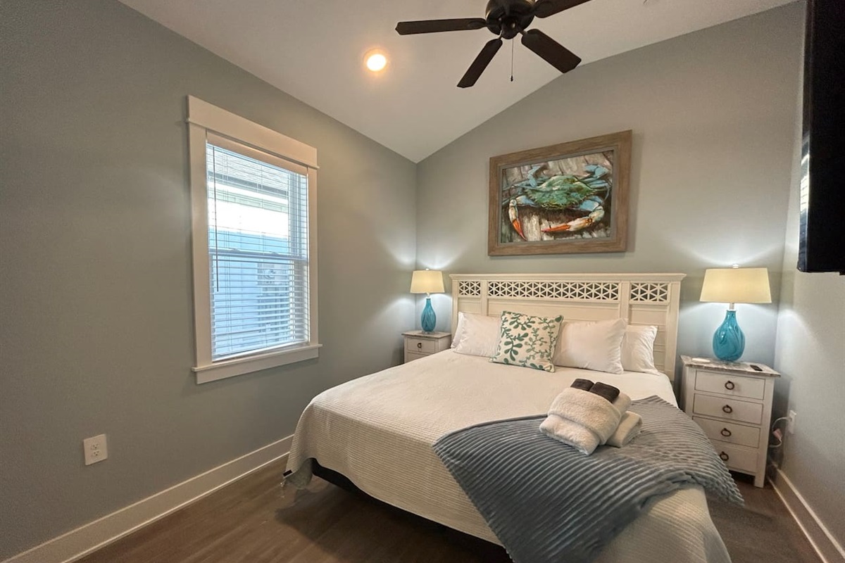 King bedroom is well decorated and has cathedral ceilings.