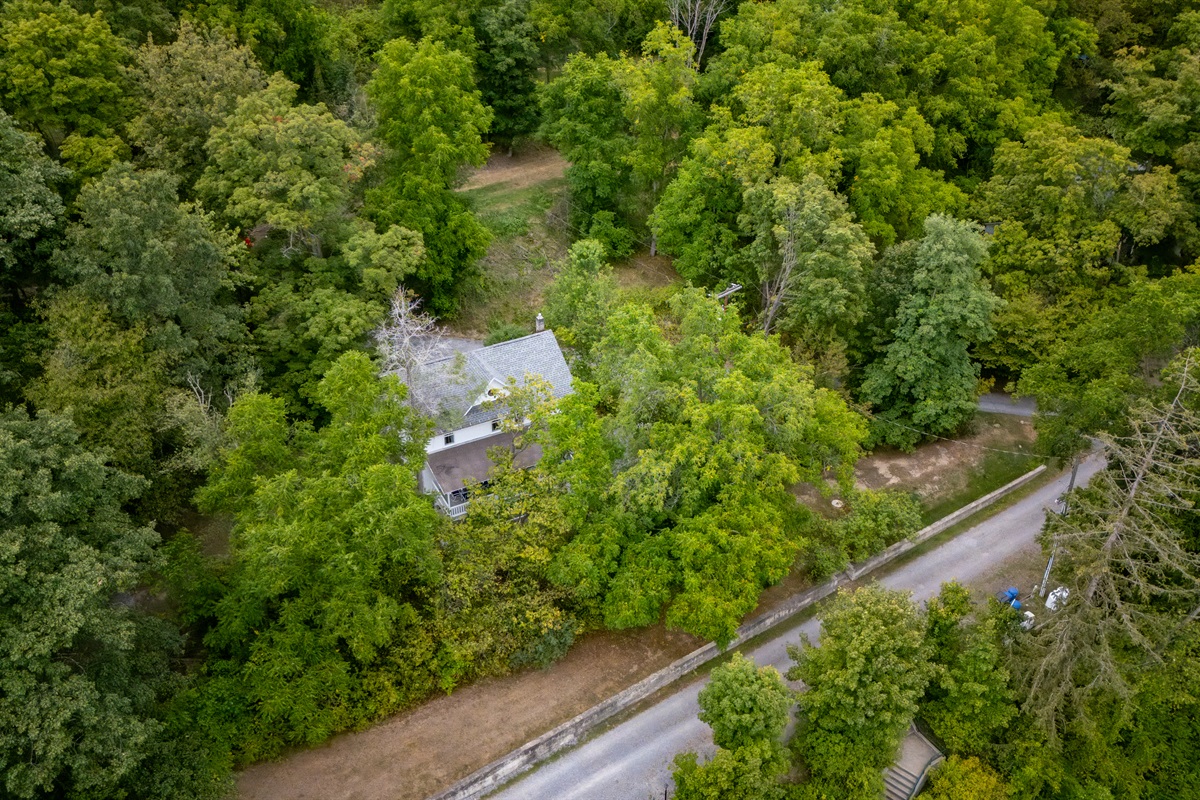 Nestled among lush trees, this charming home offers ultimate seclusion and privacy while being just steps from the lake.