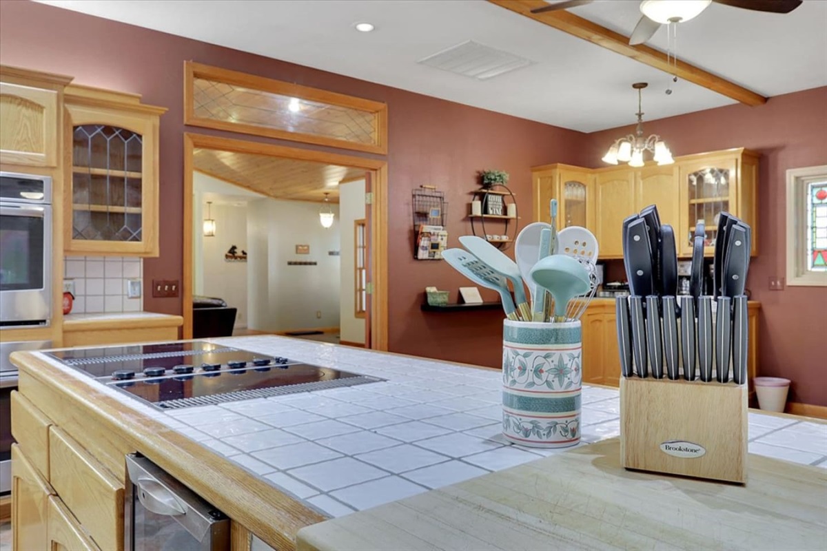 Kitchen island with cooktop, knife set, and easy access to the dining area.
