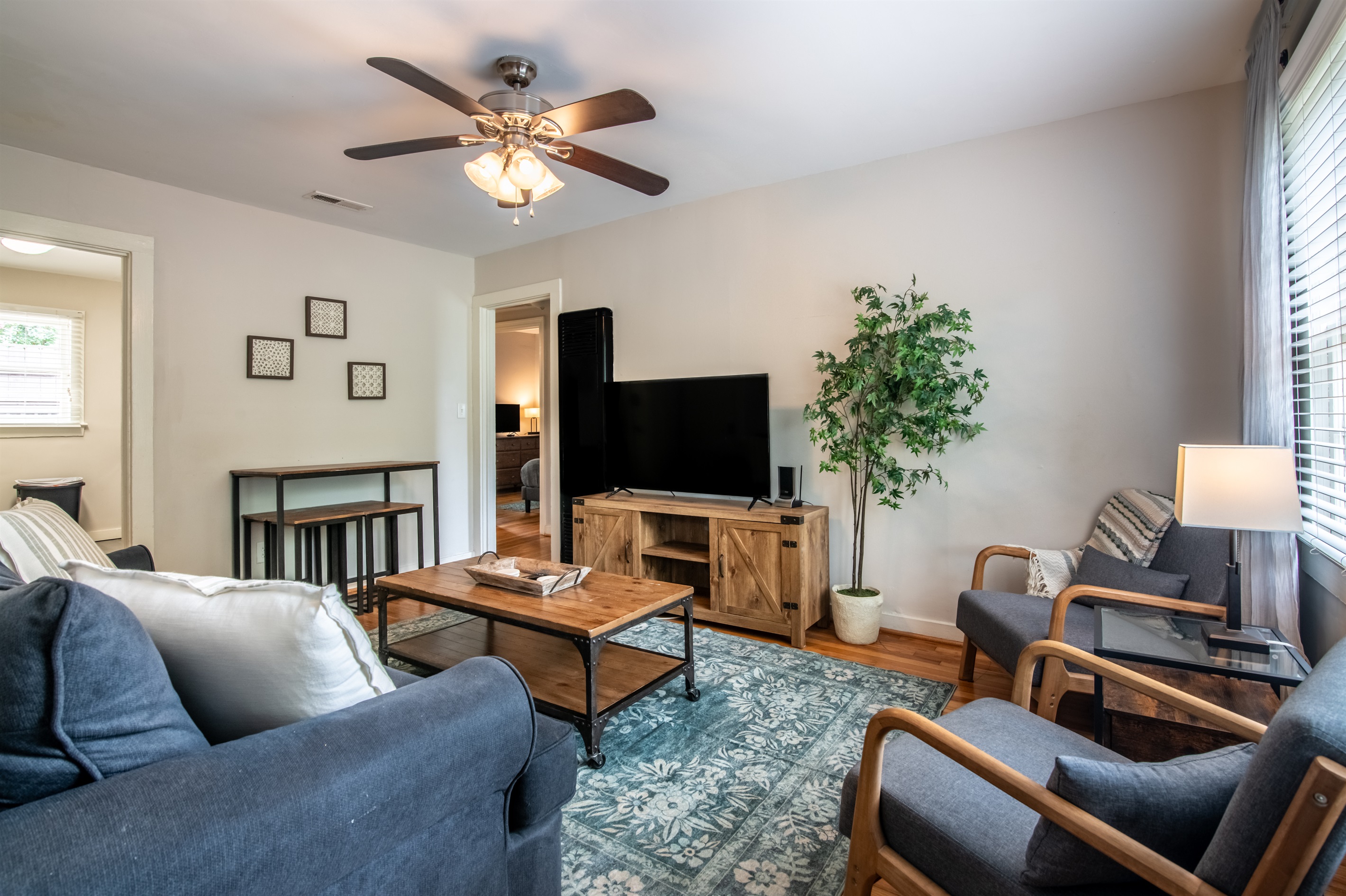 Stylish and spacious living room with natural accents and a calm, homey feel.