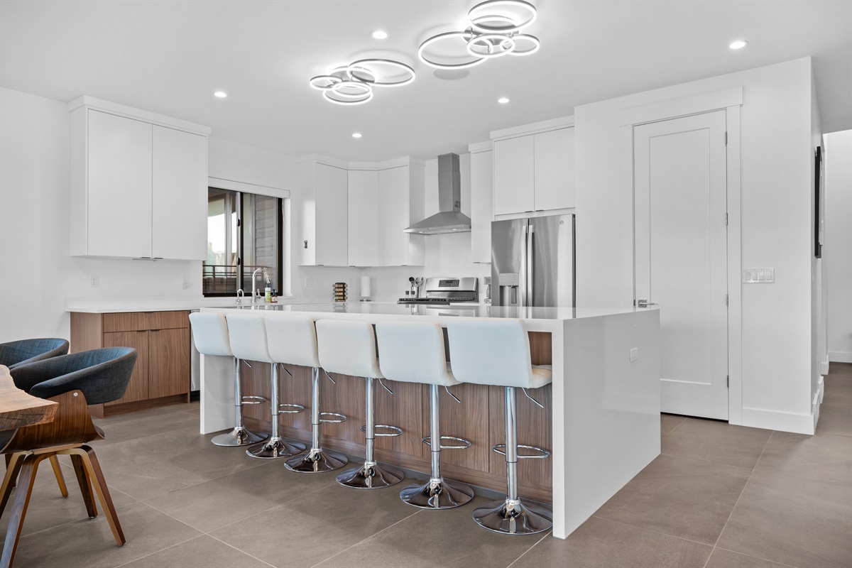 Contemporary kitchen featuring designer lighting, premium finishes, and ample counter space.