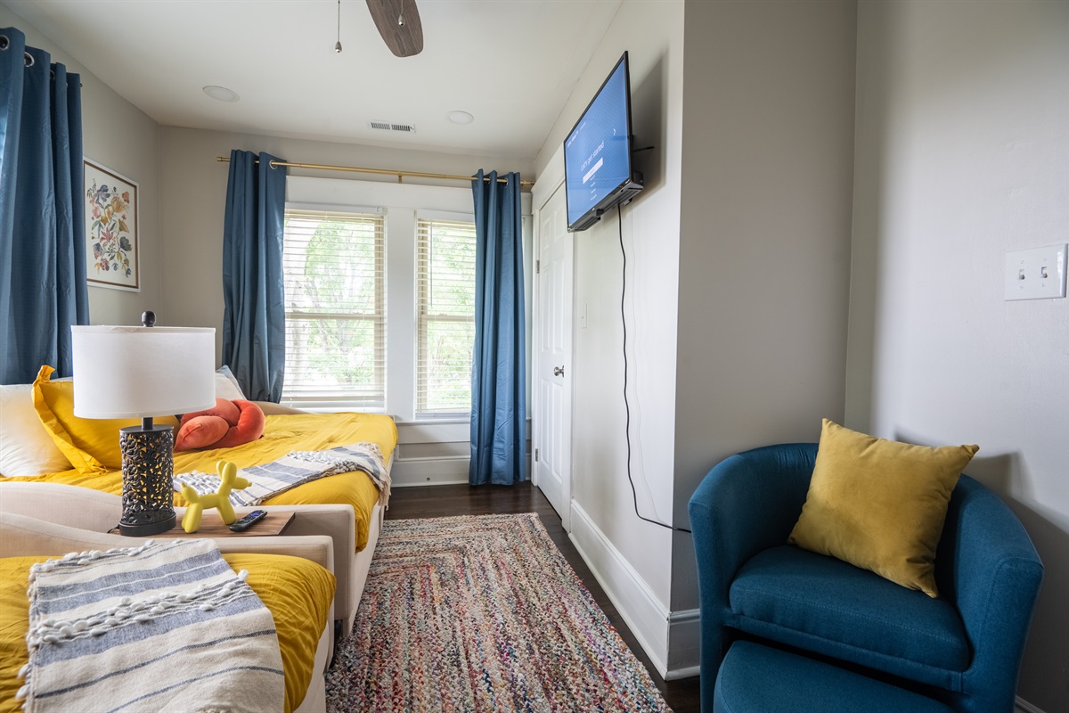 This inviting guest bedroom offers two full-sized daybeds complete with ample under-bed storage and a smart TV. Designed with both comfort and functionality in mind, your guests will feel righ