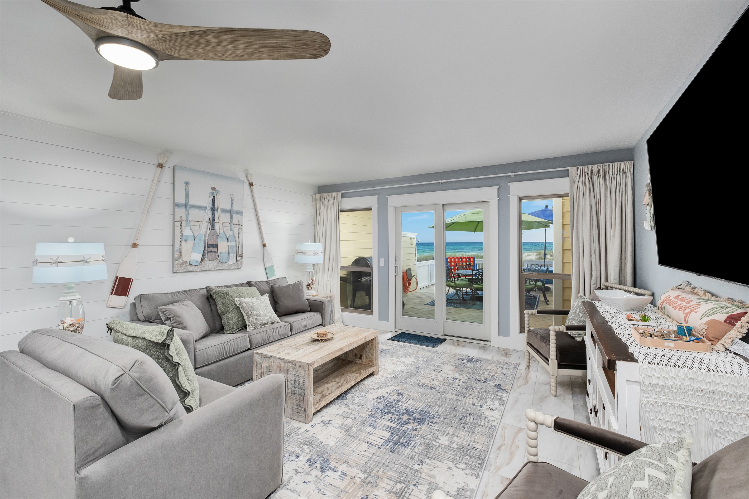 Cozy living room with direct access to the oceanfront deck. Perfect for a relaxing beach getaway.