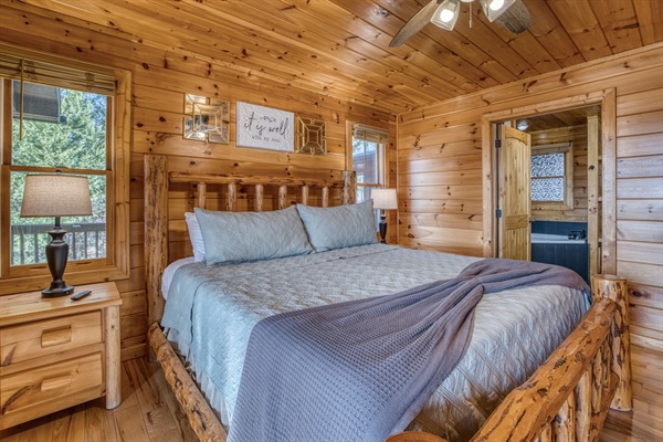 Main-level master bedroom includes a king bed, a private full bathroom, and mountain views! The screened-in patio is right off the master bedroom. 