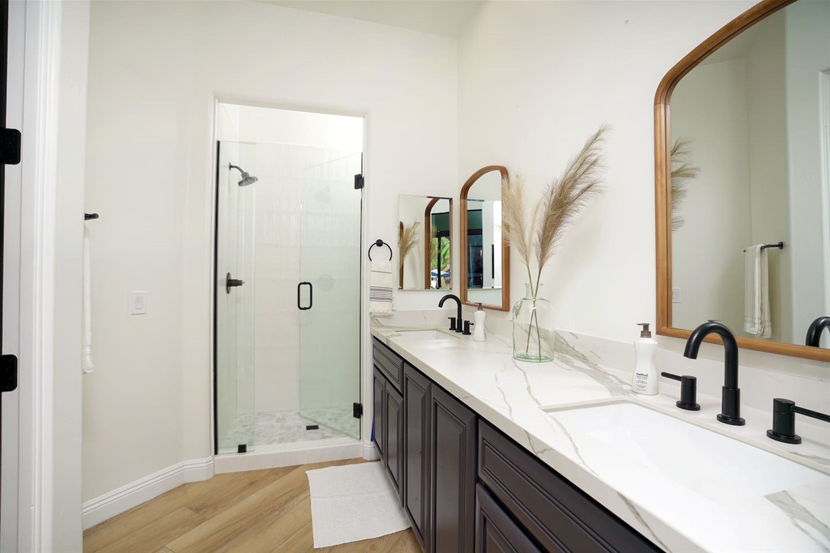 Bedroom four bathroom with shower, dual sinks, and private water closet.