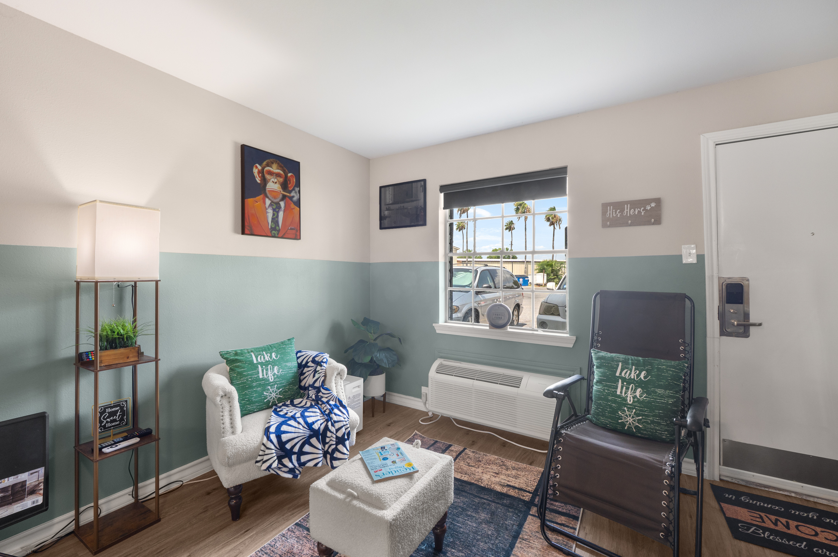Open living area with a chair, TV, window view, and a simple spot to relax.
