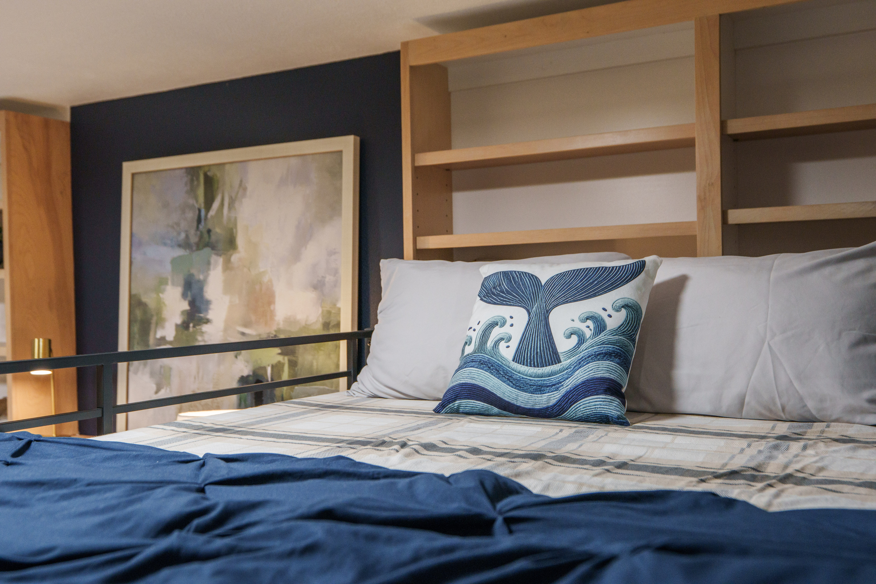 Bedroom 2 is thoughtfully designed for families and groups, featuring a queen bed, a queen-over-queen bunk bed, a dedicated remote-work desk, and a private ensuite bathroom (Bathroom 2)