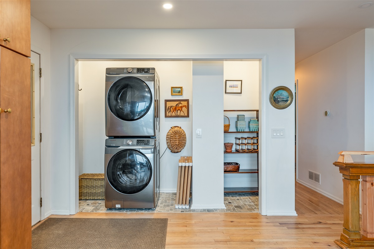 Enjoy the convenience of a sleek, modern washer and dryer set tucked in a stylish laundry nook with extra shelving for easy organization