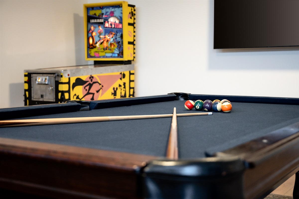 Game garage with arcade game (old school ping pong), & pool table with convertible tabletop with ping pong. Card table and variety of family games