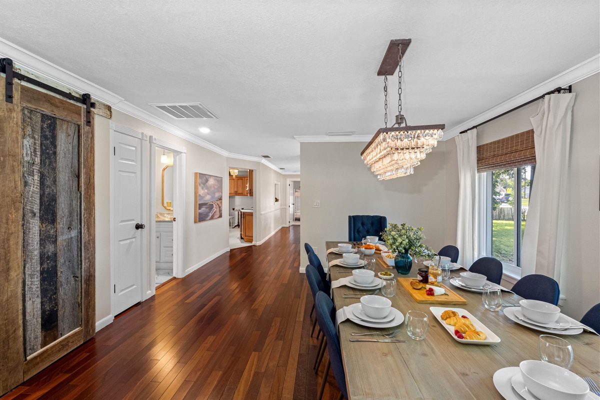 The dining area flows seamlessly into the living spaces, offering a warm and inviting atmosphere.