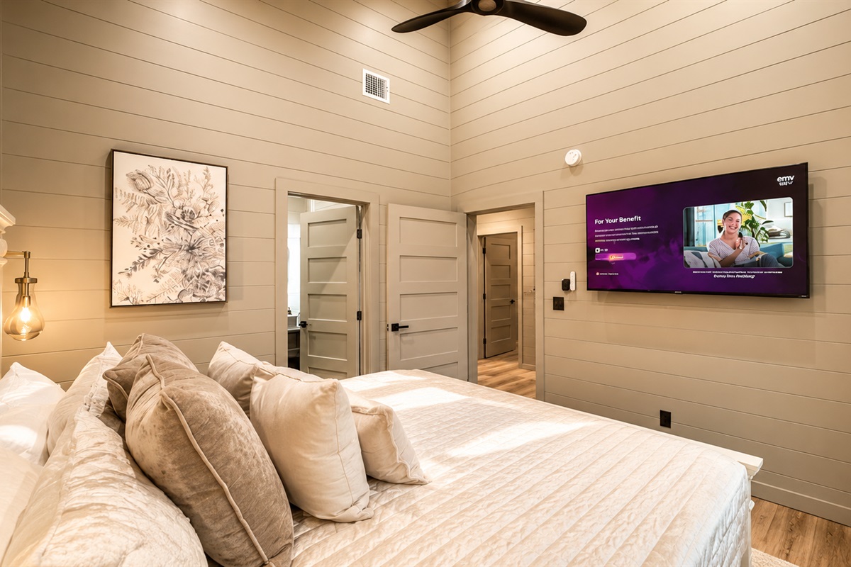 Bedroom Retreat: Stylish decor, plush bedding, and a TV for your evening entertainment!