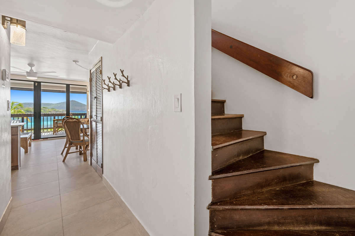Beautifully designed staircase leading to the private second-floor retreat.