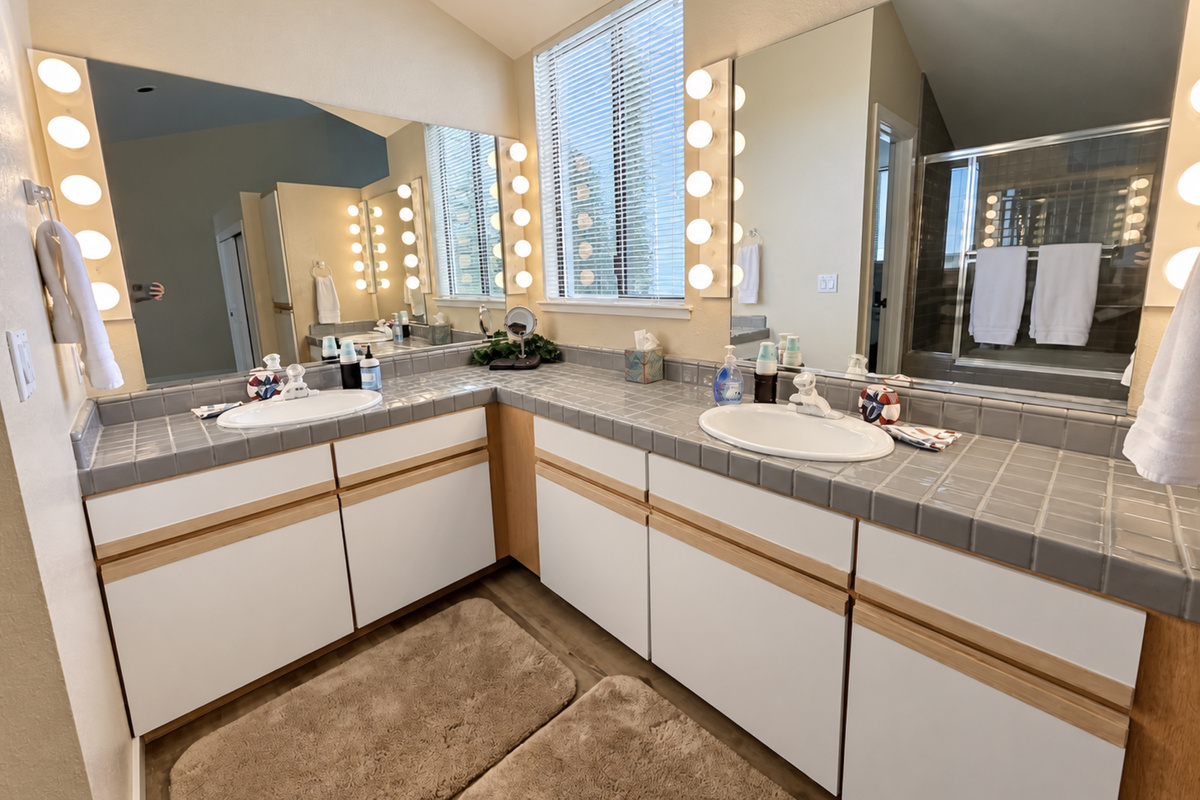 Master bathroom with double vanity in Master Suite. Sunken shower/tub combo with assistance rail for in/out.