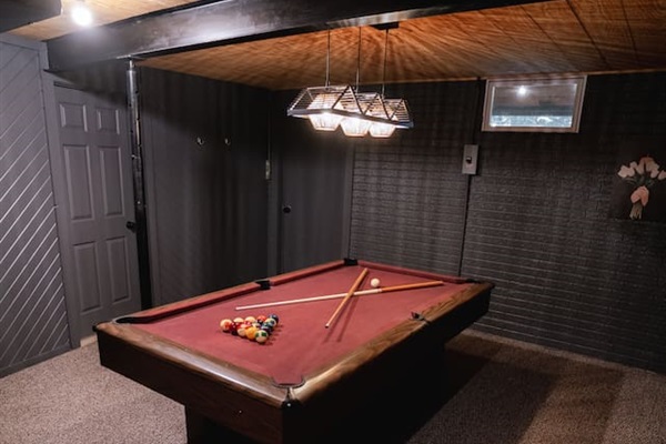 Challenge friends to pool in the cozy basement game room.
