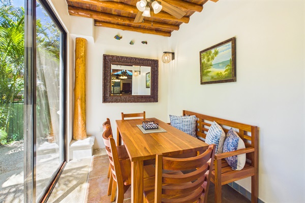 Indoor dining room.  Custom locally made indoor dining table offers seating for 6 people in addition to kitchen island seating for 3.  Sliding patio doors from dining room lead to beautifully, mature landscaped front yard