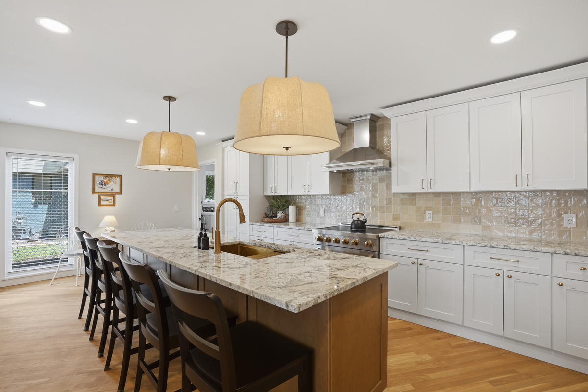 Prepare meals with ease in this beautifully updated kitchen featuring a large granite island, premium appliances, and seating for the whole group. The open layout provides plenty of space to cook, dine, and connect, making it the heart of the home for fami