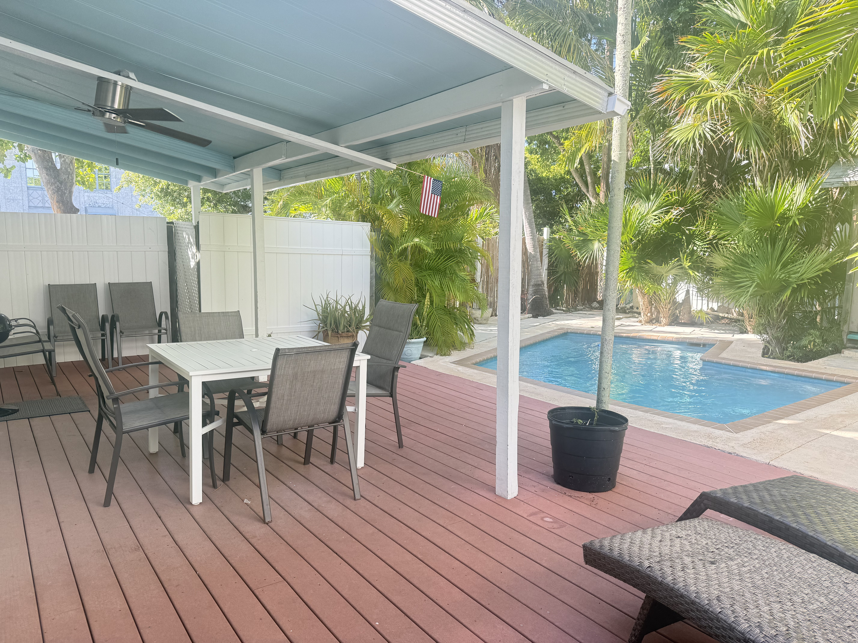 Unwind in your private tropical oasis, where lush greenery surrounds a serene pool. Sip your morning coffee or enjoy an al fresco meal on the spacious deck