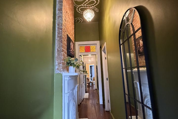 Original hardwood floors, a full-length mirror, serpents curling across the ceiling, and art that makes you look twice. La Lune Noire doesn't wait to cast its spell.