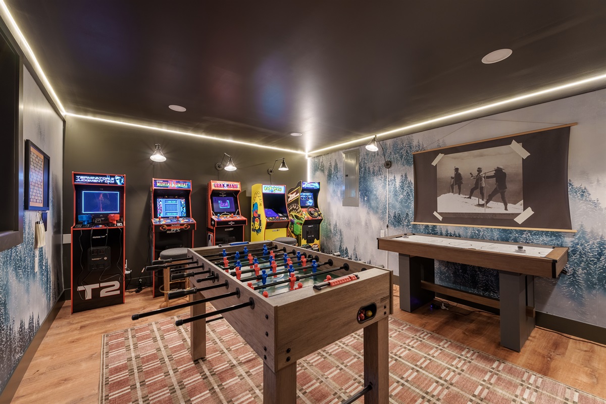 Fully loaded game room featuring classic arcades, foosball, air hockey, plus wall-mounted Scrabble, Connect-4, and ring toss for endless group fun.