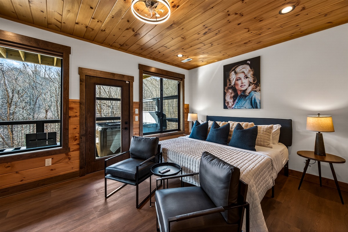 Relax in the spacious king bedroom on the game room level with a big TV, desk & direct deck hot tub access. Unwind in the en-suite bathroom featuring a walk-in shower with a natural river rock floor, bringing  the Smoky Mountains indoors for a spa retreat.