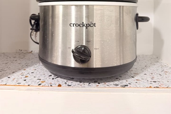 A fully stocked kitchen includes convenient tools like a Crockpot — great for easy meals after busy days.