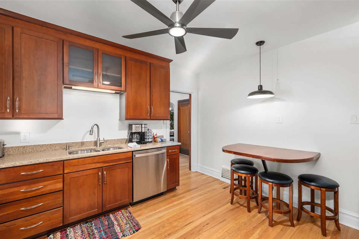 Kitchen with gas range, microwave, dishwasher, full kitchen utensils, plates, bowls, (kids cups and dishes), toaster, blender, waffle maker, and cookware.  Additional dining space for 4.