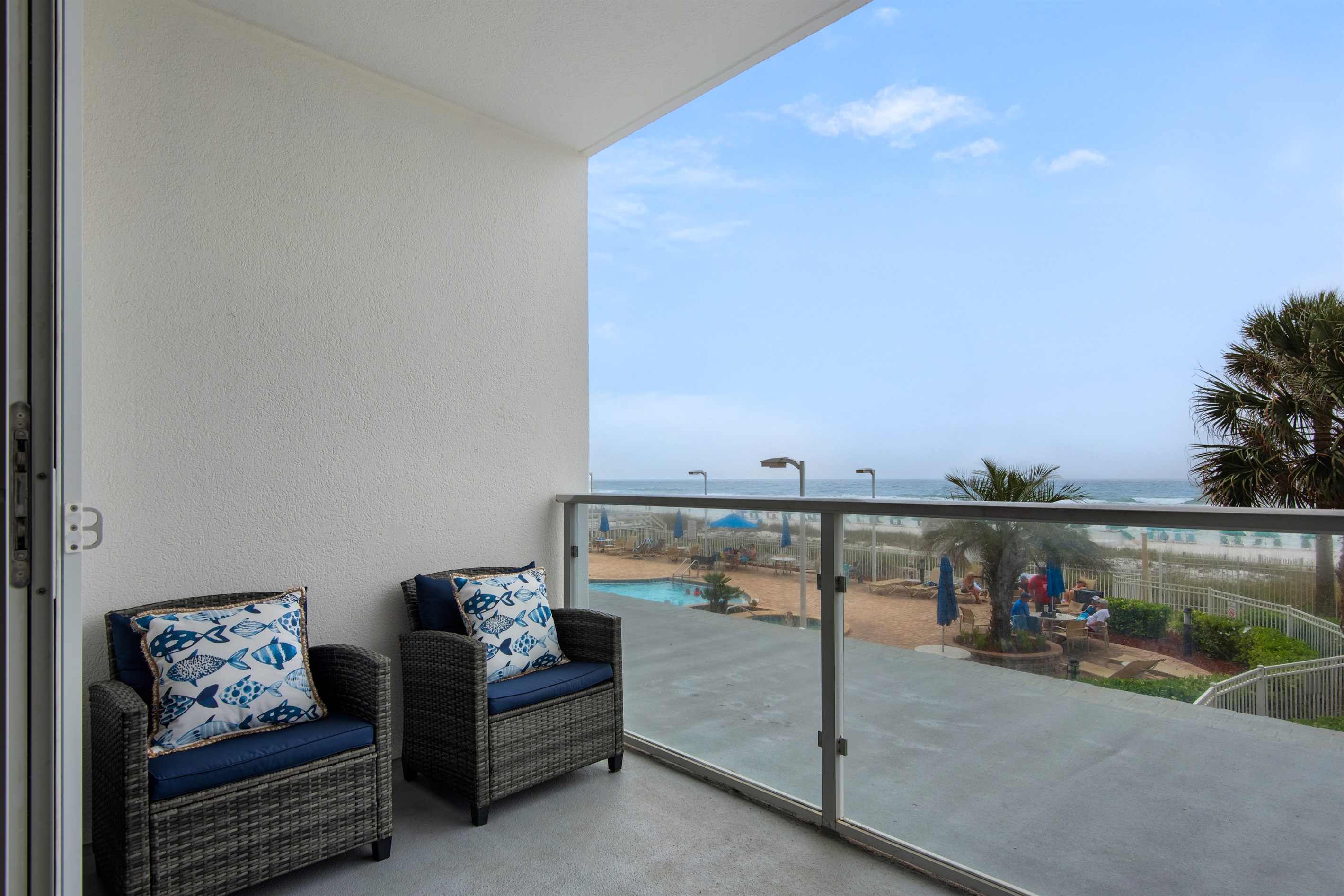 Balcony seating overlooking pool and beach