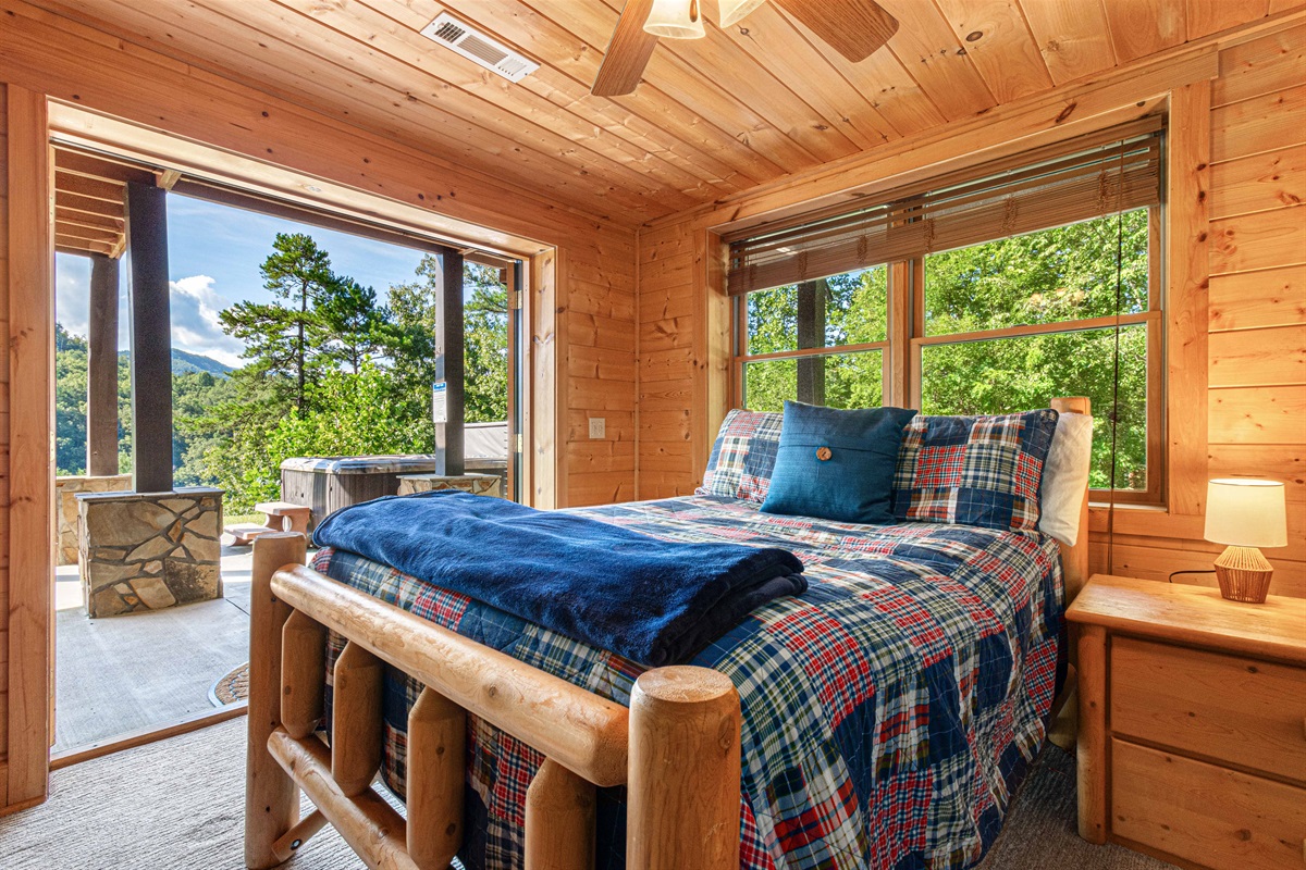 Downstairs Bedroom 1: Embrace mountain views from this inviting retreat with rustic charm!