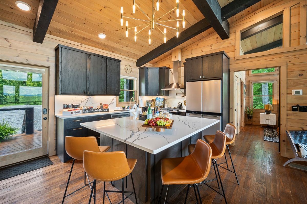 This sleek, modern kitchen with a large island is ideal for hosting and enjoying time with family and friends.