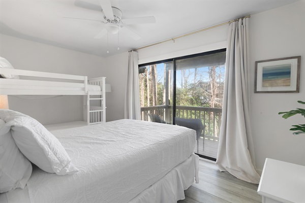 Charming Guest Bedroom: This room boasts a comfortable queen bed and a fun bunk bed setup, complete with a private balcony, making it perfect for families.