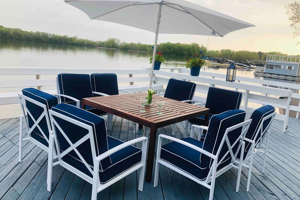 Private deck overlooking the lake! With two sets of these tables, chairs, and umbrellas, everyone can gather around and enjoy this beautiful view. 