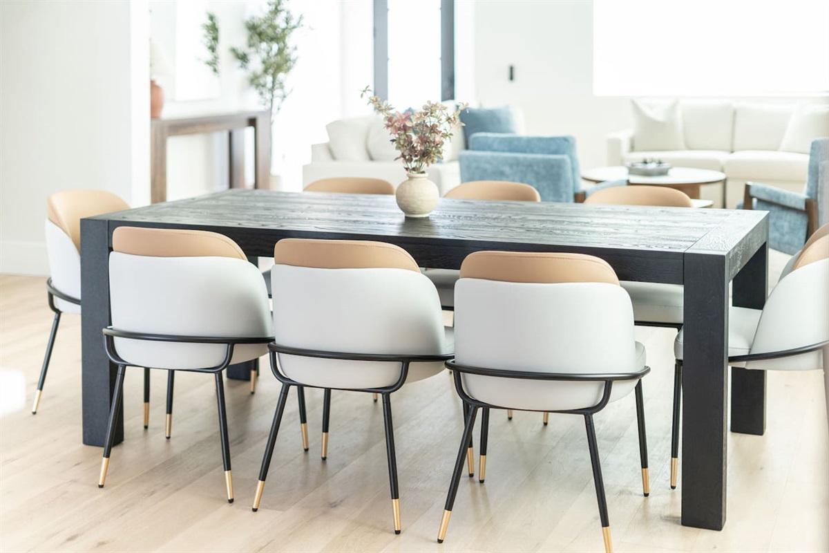 The rich wood grain table and chic centerpiece set a refined tone for memorable meals.