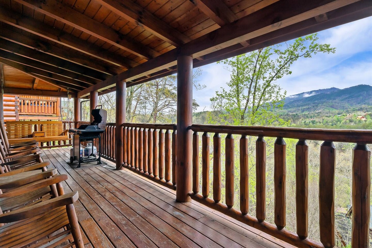 Beautiful views from the upper deck.Easy access from the main floor.Propane grill, porch swing, rocking chairs.Hot tub located behind photographer.