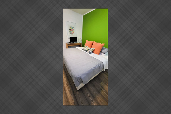 King sized bed with a desk and computer monitor with HDMI connector